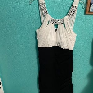 White and black mini dress with a studded silver beading along the neck line.